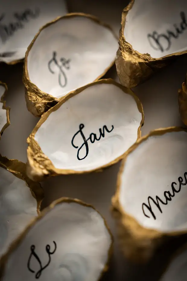 Oyster shell wedding place cards with modern calligraphy