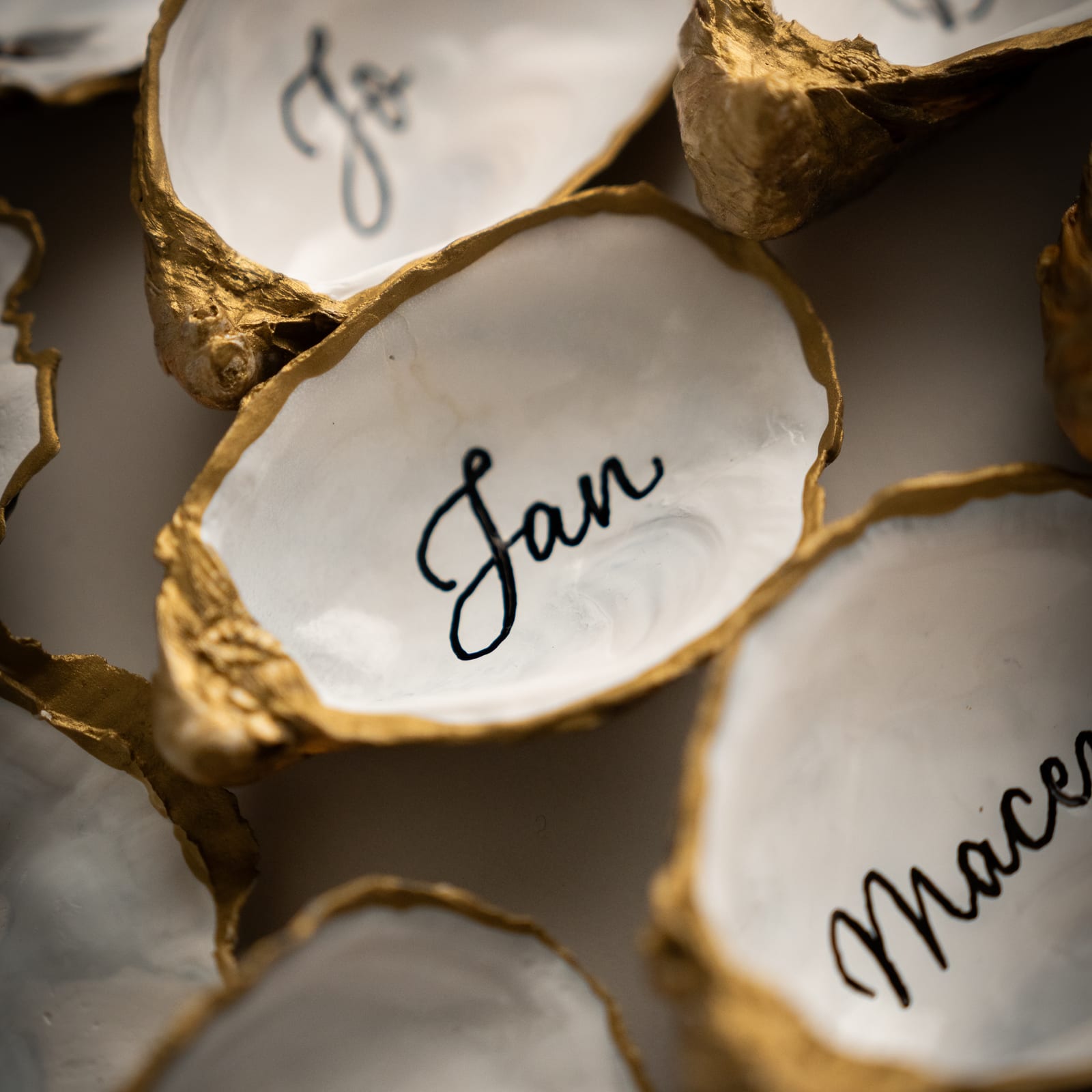 Oyster shell wedding place cards with modern calligraphy