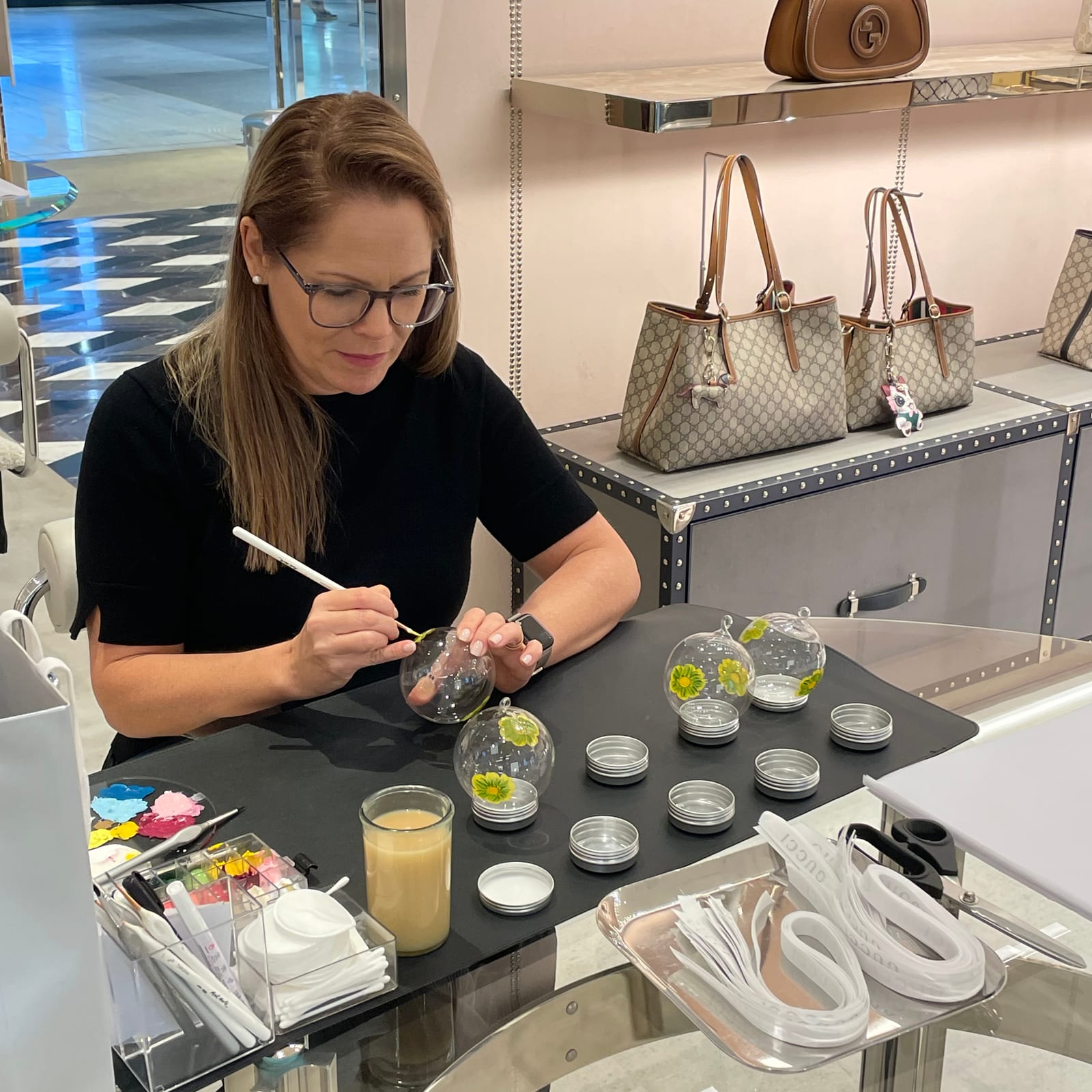 Alison painting glass baubles in the Gucci Pacific Fair boutique
